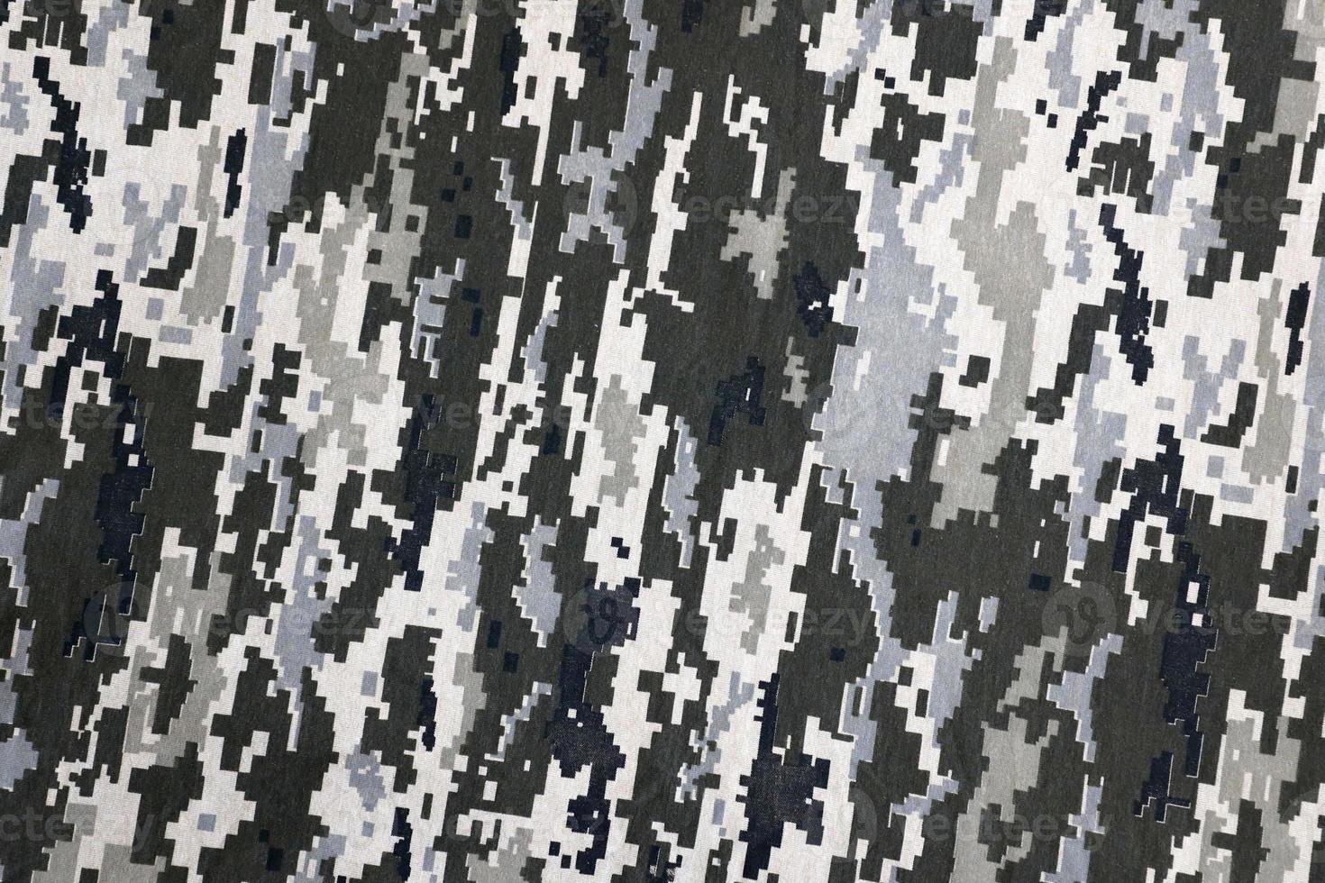 Fabric with texture of Ukrainian military pixeled camouflage. Cloth with camo pattern in grey, brown and green pixel shapes. Official uniform of Ukrainian soldiers photo