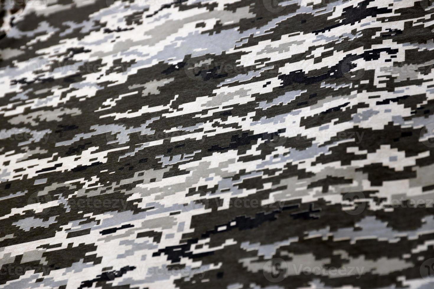 Fabric with texture of Ukrainian military pixeled camouflage. Cloth with camo pattern in grey, brown and green pixel shapes. Official uniform of Ukrainian soldiers photo