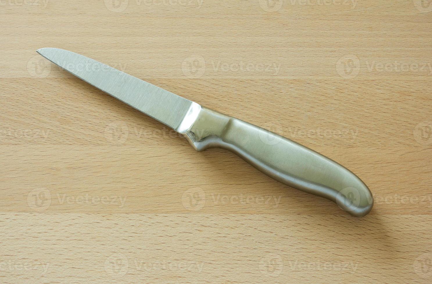 kitchen knife on brown wooden board photo