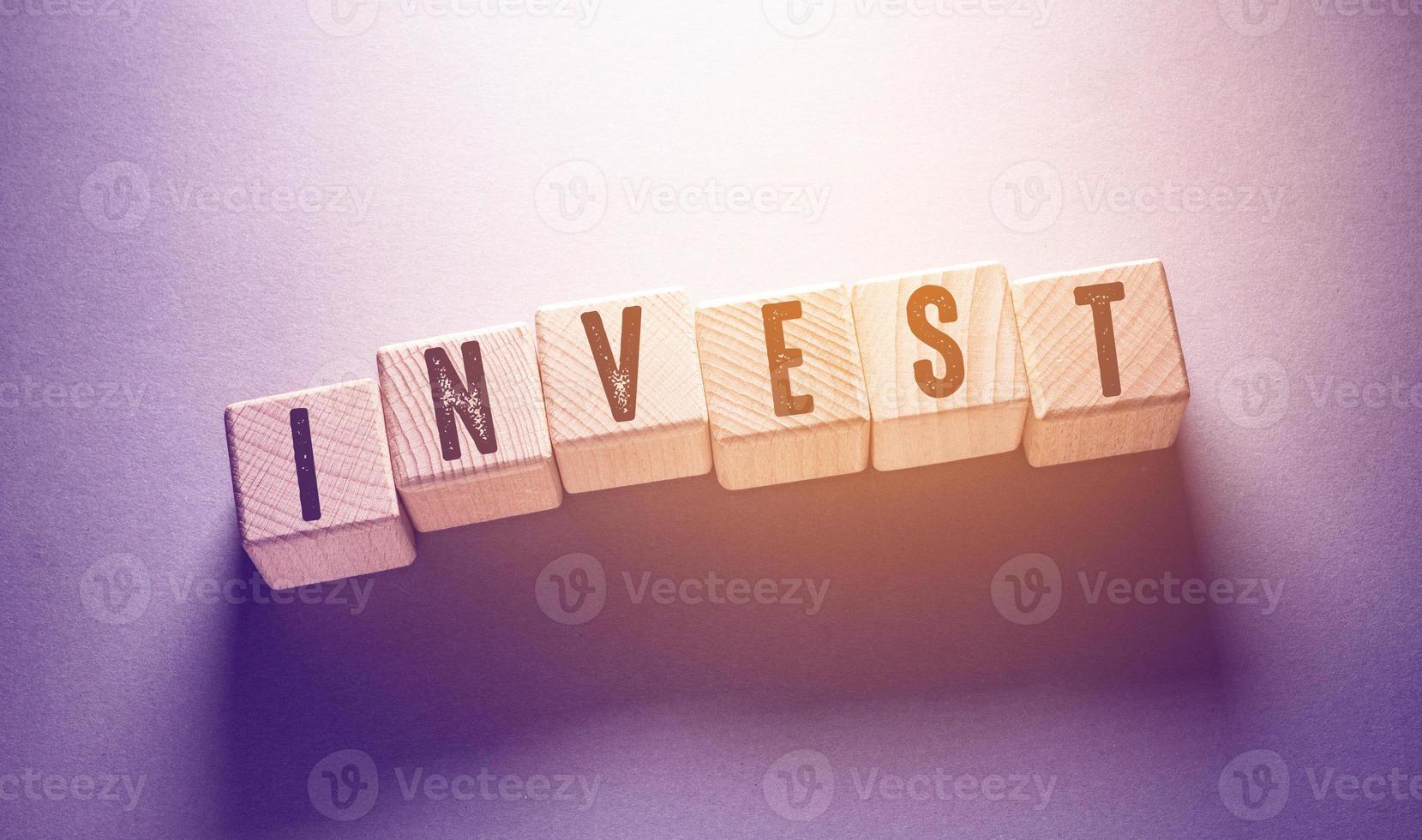 Invest Word with Wooden Cubes photo