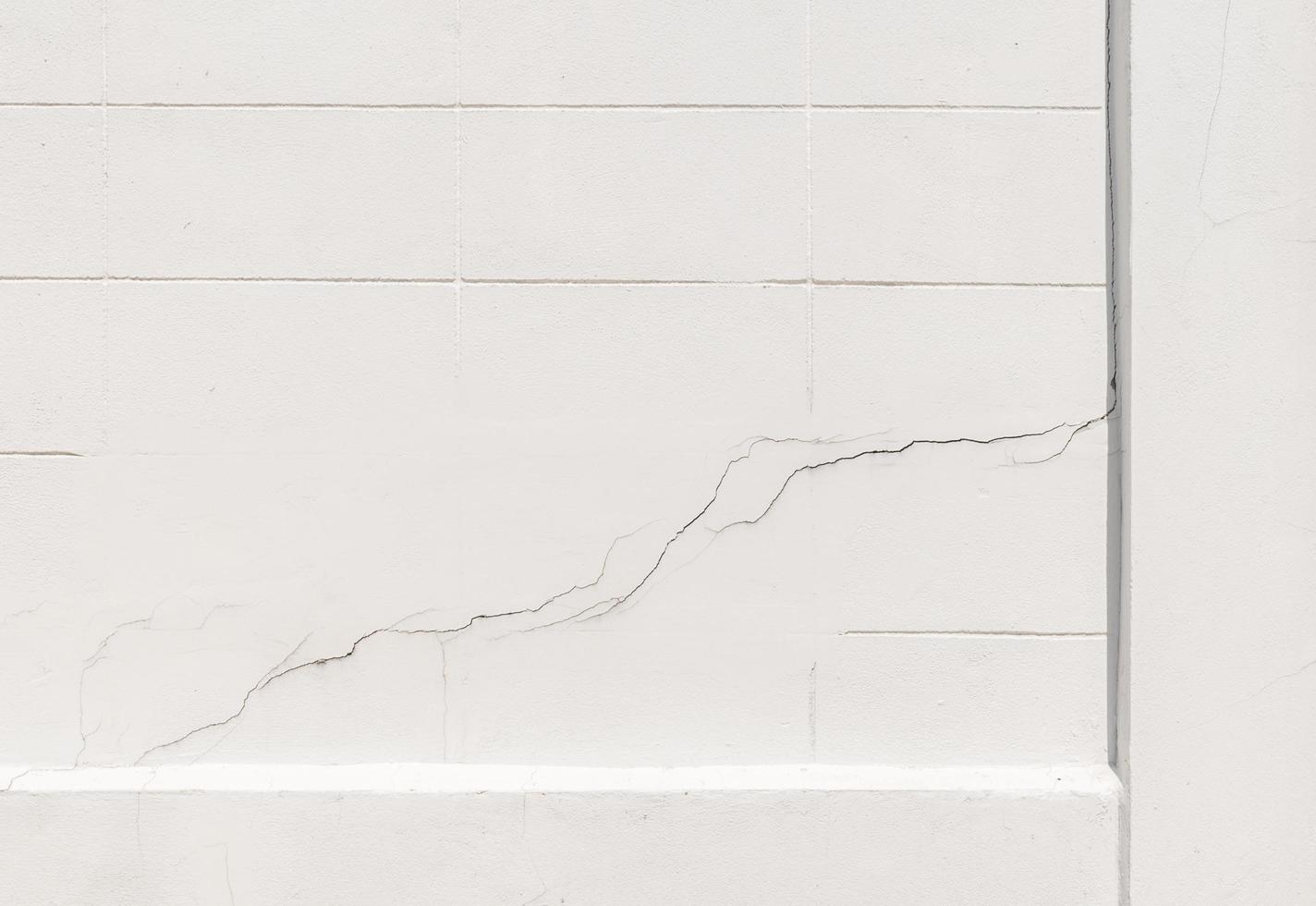 Texture white concrete wall has cracks photo