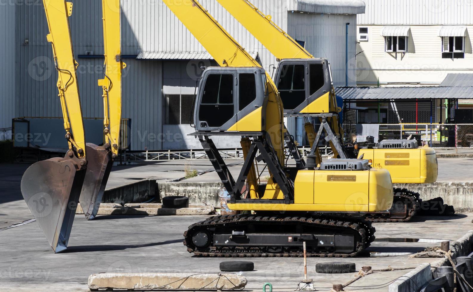 Two yellow backhoe on dock photo