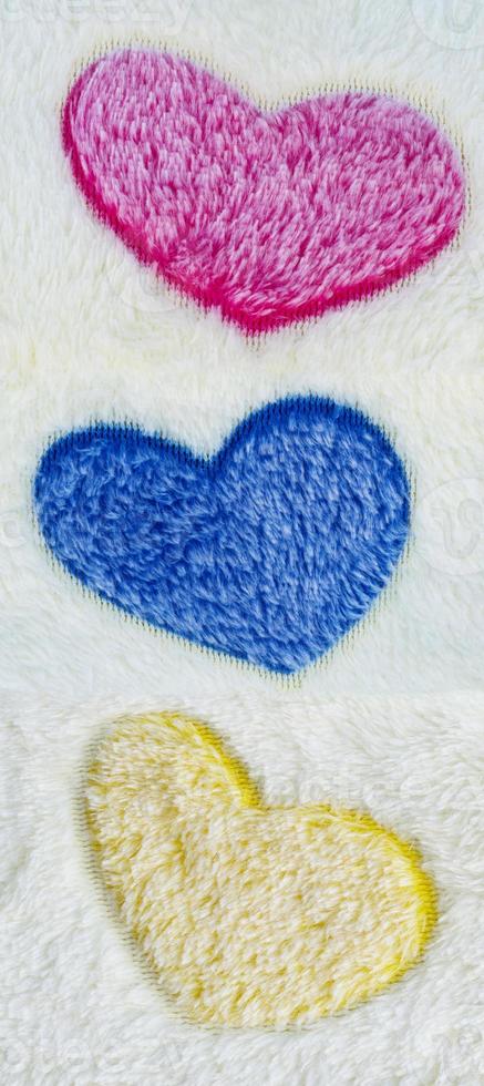 Wool rug texture with colorful heart pattern background photo
