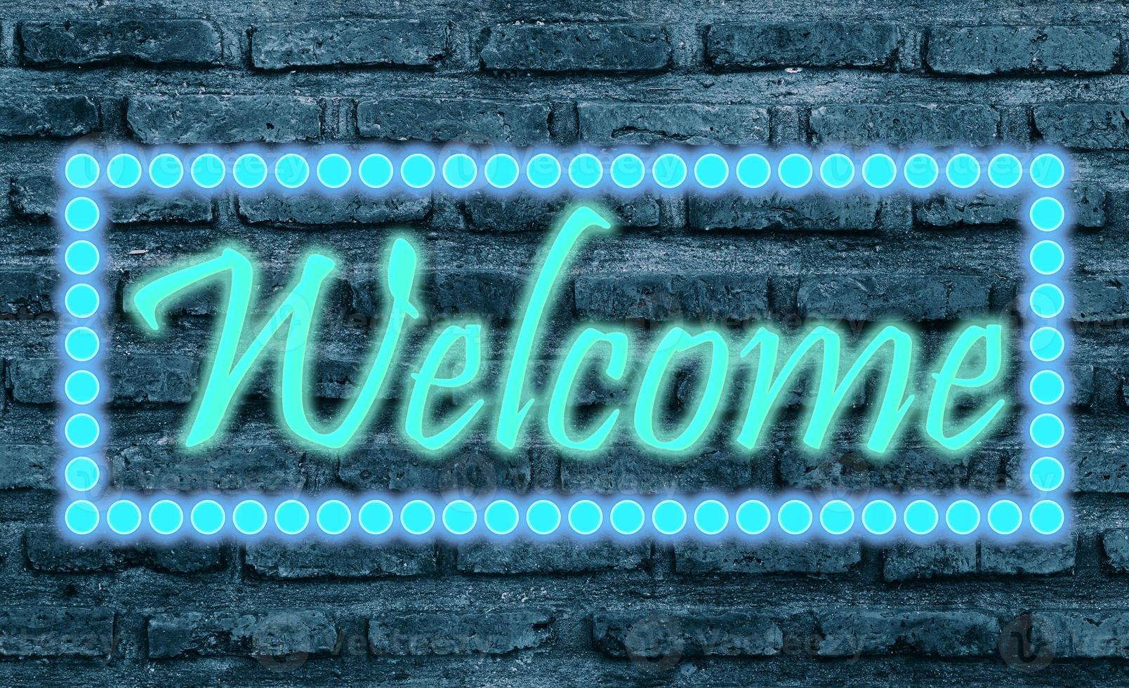 Message Welcome with effect neon light on black brickwall photo