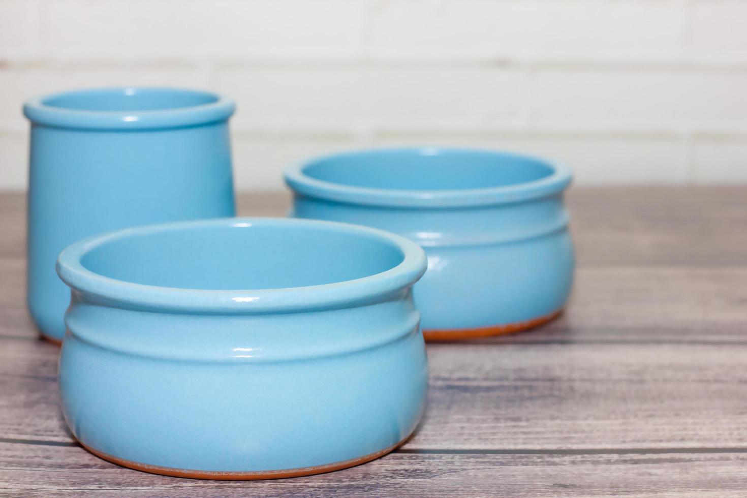 clean empty ceramic blue bowls on wooden background. photo