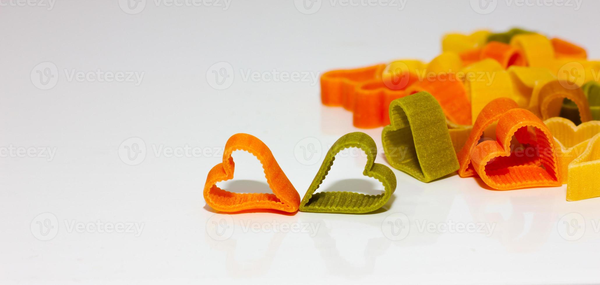 colored pasta in the shape of a heart on a light background. Healthy food concept. Soft focus photo