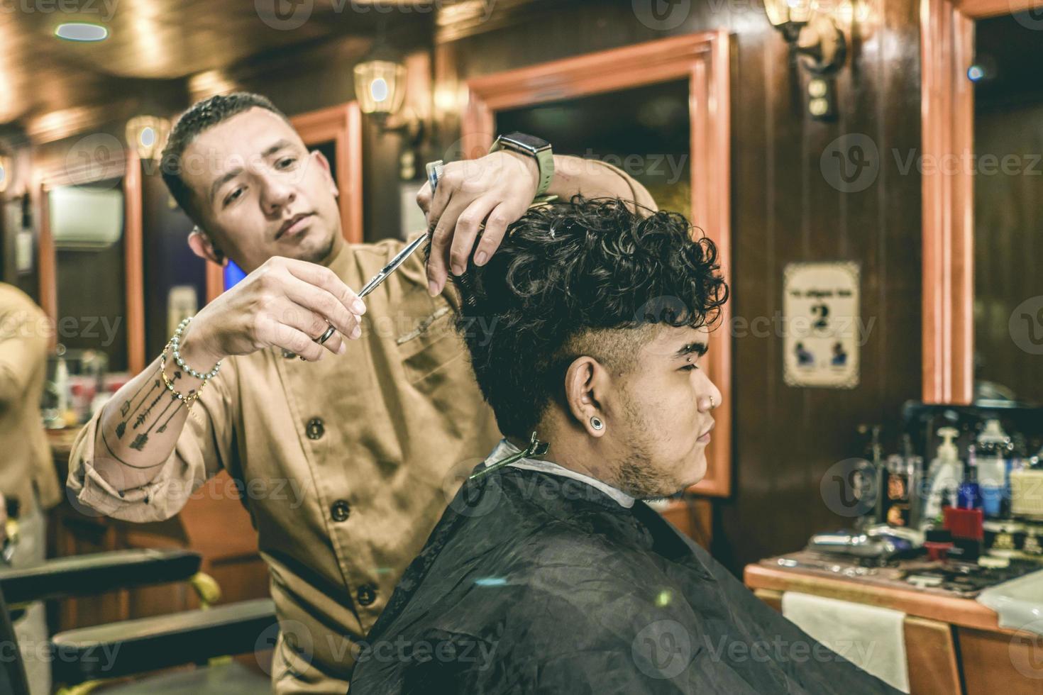 Barber Cutting Hair to a Client at Barber Shop photo