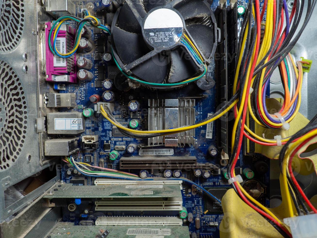 The stuffing of an old computer is in the dust. photo