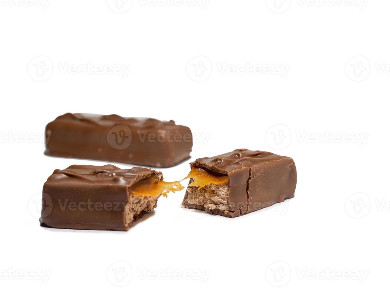 Broken chocolate bar on a white background. Slices of chocolate. photo