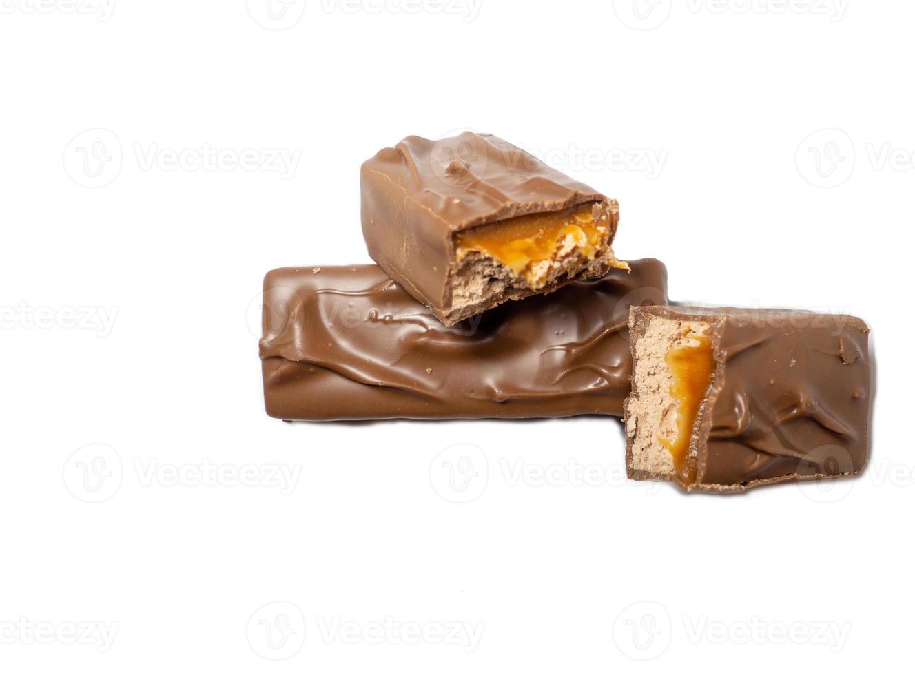 Broken chocolate bar on a white background. Slices of chocolate. photo