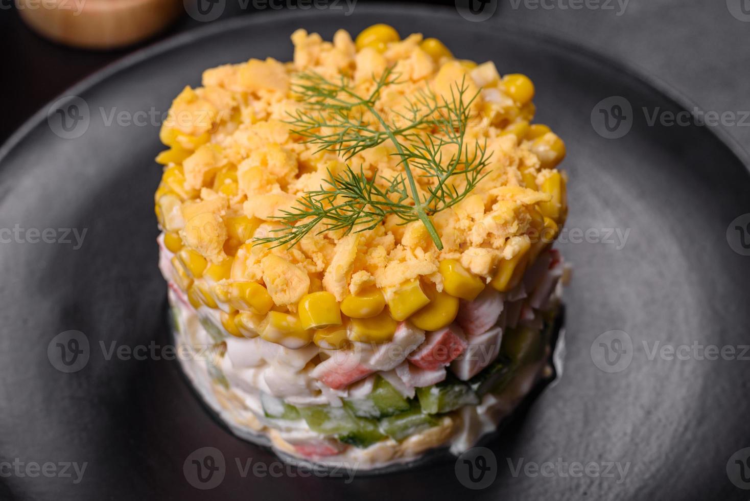 Fresh vegetable salad with corn, pepper, crab, cucumber, eggs and mayonnaise photo