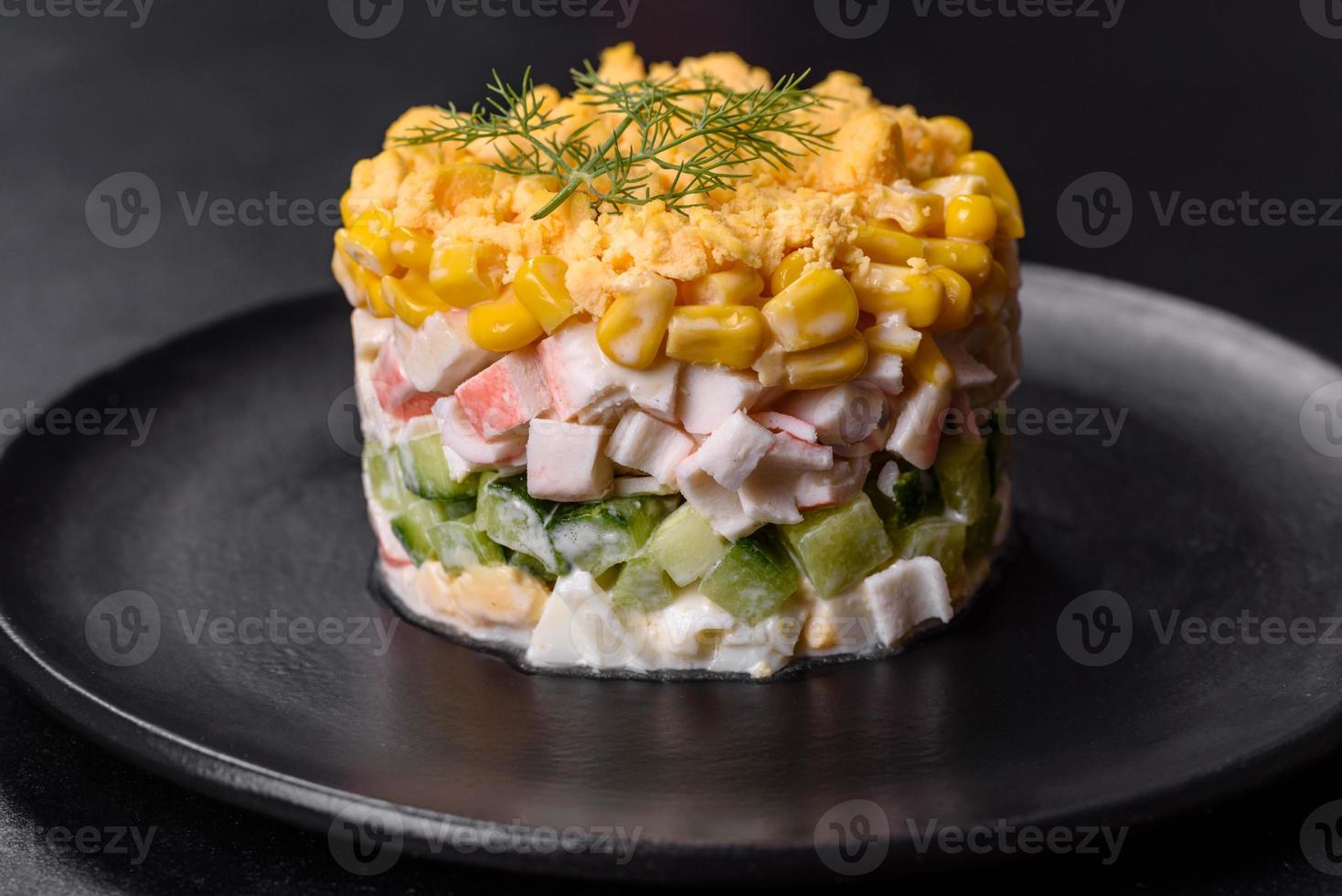 Fresh vegetable salad with corn, pepper, crab, cucumber, eggs and mayonnaise photo
