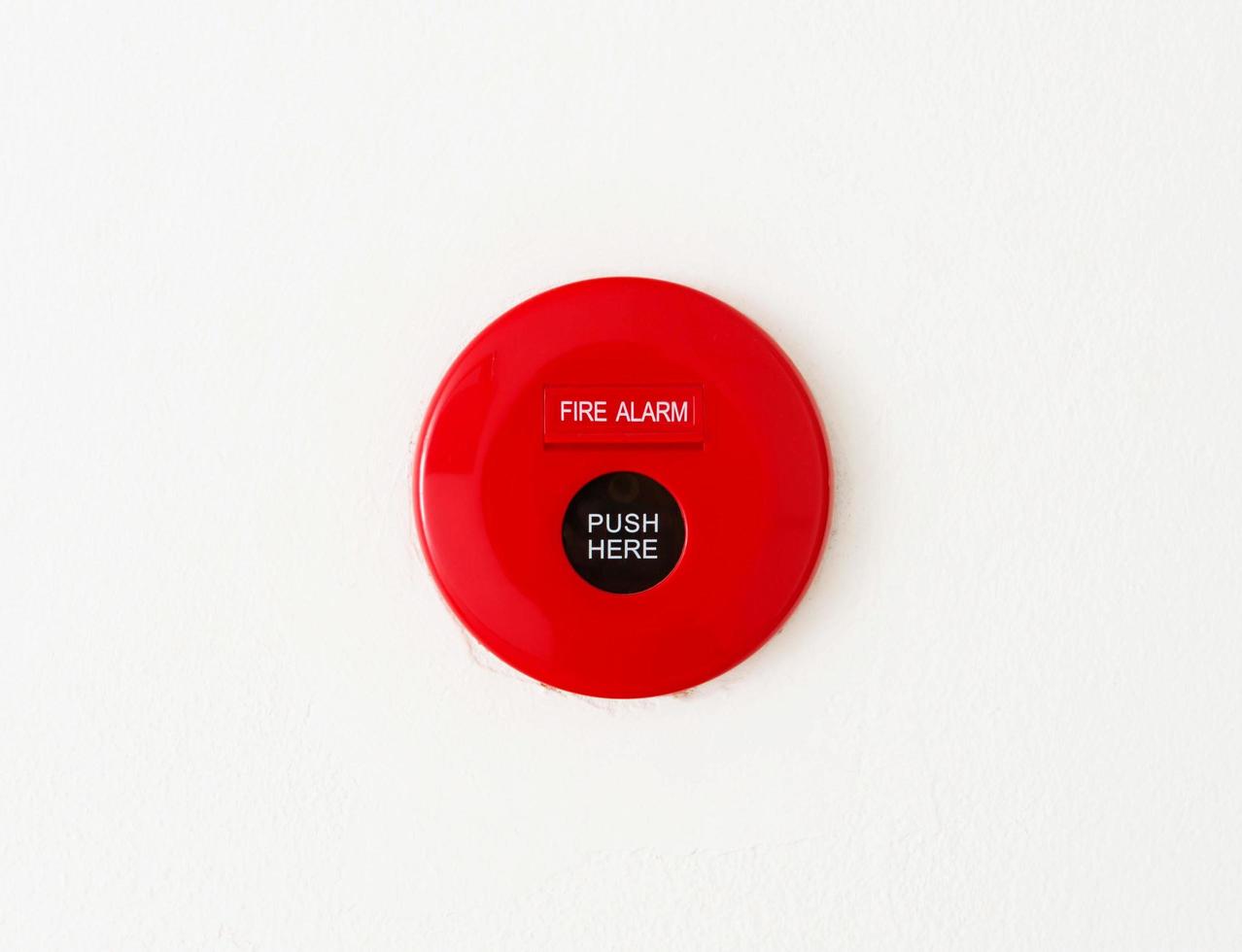 red fire alarm on wall photo