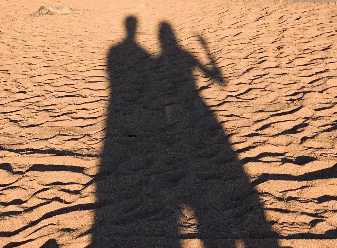 Cute couple shadow on the beach photo
