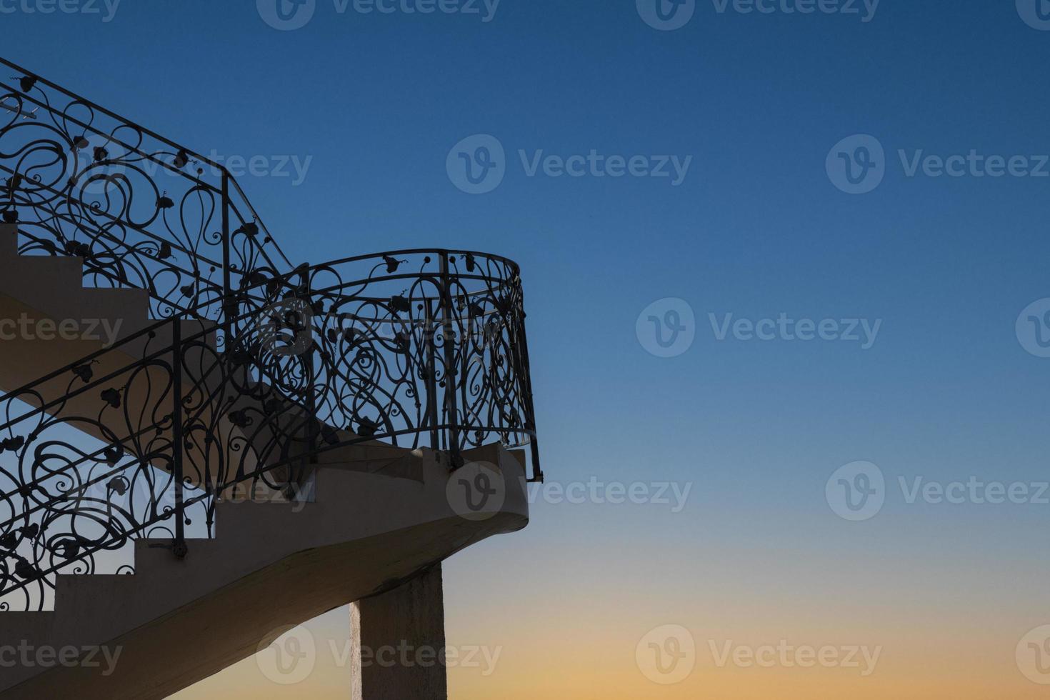 Staircase with metal railing outdoors at dawn. Concept way to the sky. photo