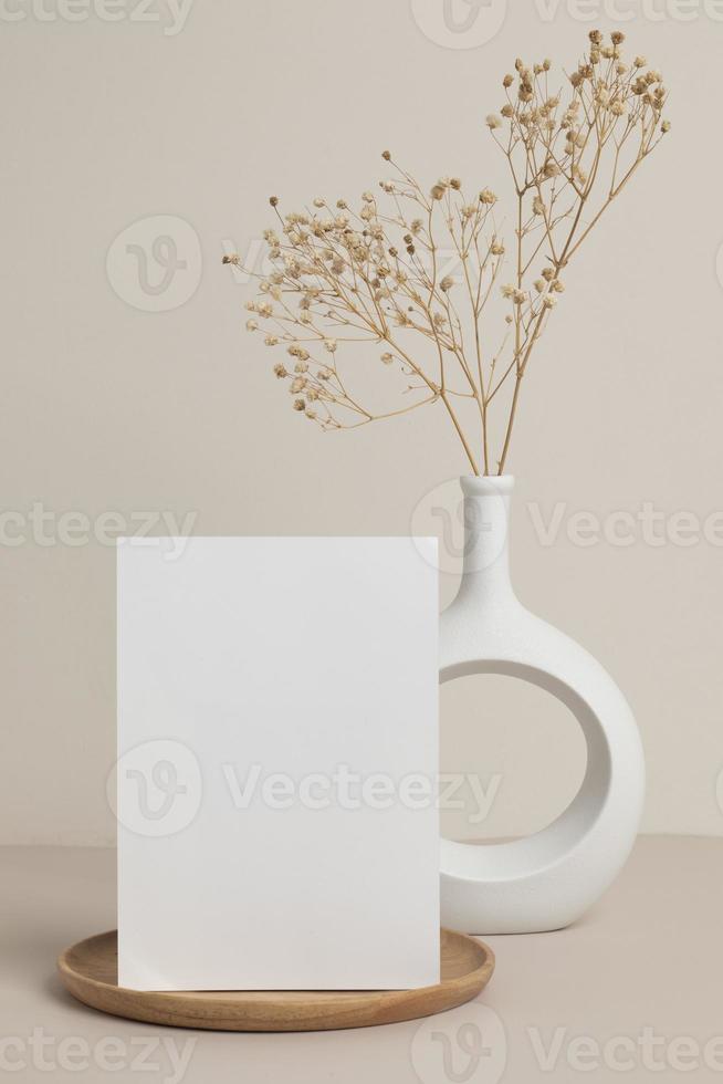 greeting card front view and dry flower in vase ceramic on table photo