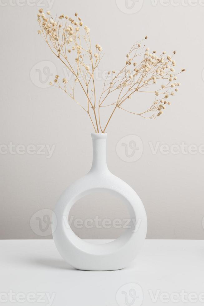 dry flower in vase, nordic vase ceramic in beige background photo