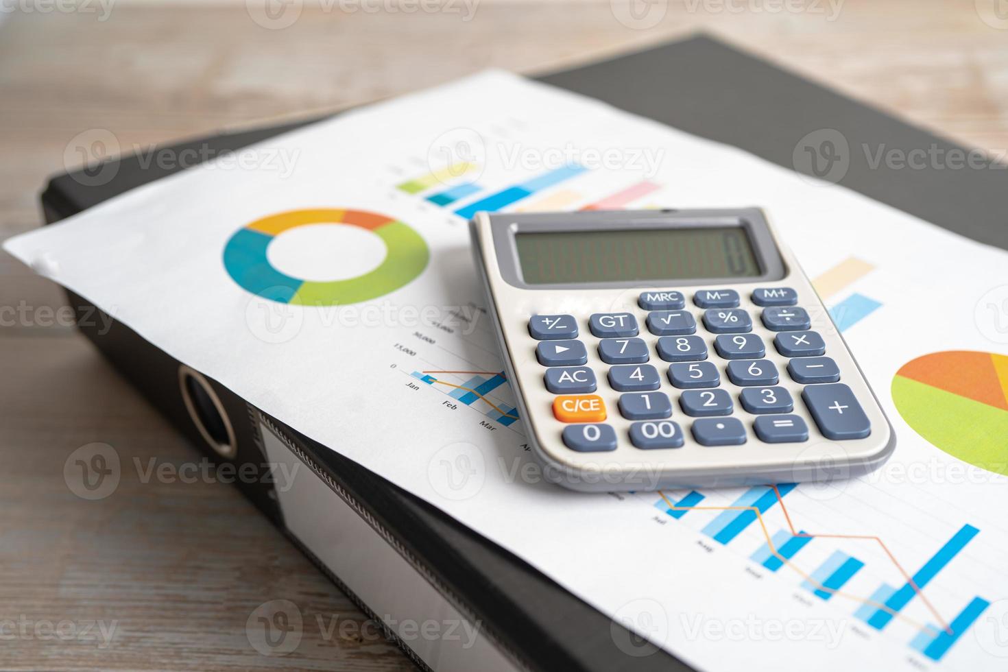 Magnifying glass and calculator on charts graphs paper. Financial development, Banking Account, Statistics, Investment Analytic research data economy, Stock exchange trading, Business office concept. photo