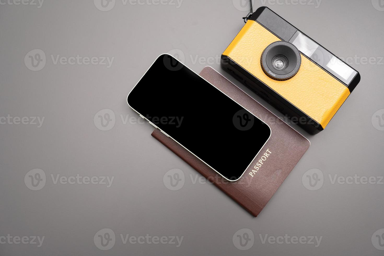 Travel Concept vintage camera, smartphone, passport, on gray background, with copy space. photo