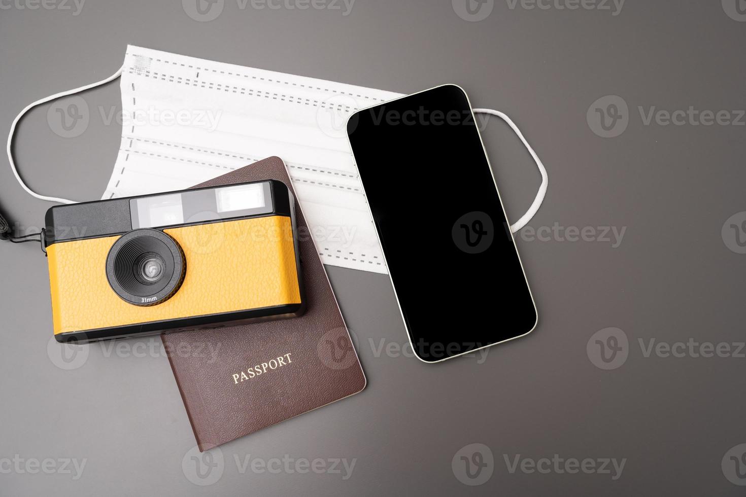 Travel Concept vintage camera, smartphone, passport, on gray background, with copy space. photo