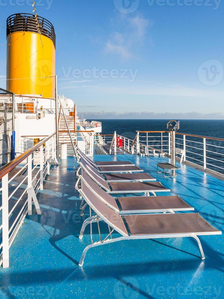 empty chairs on upper deck of cruise liner photo