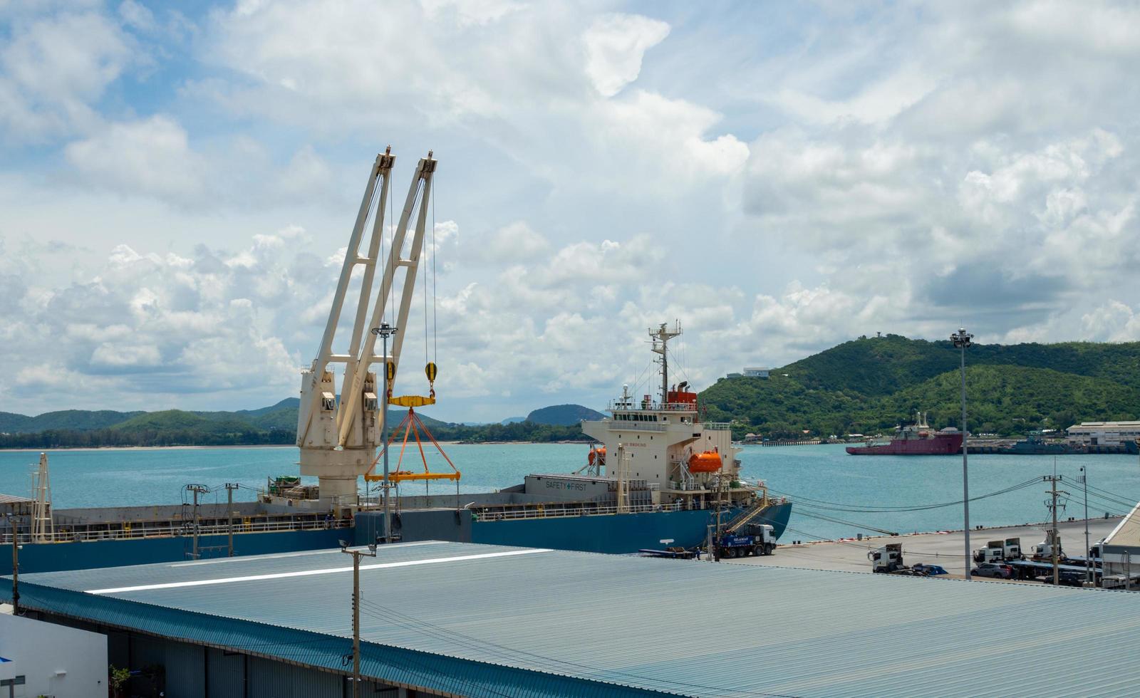 Industrial port crane lift up loading export containers box onboard at port of Thailand. photo