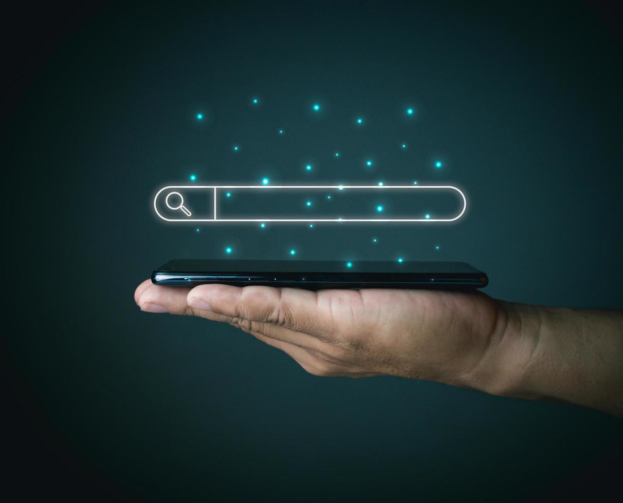 The concept of searching for information from the phone's network. with the phone placed on the lid of the person's hand. photo