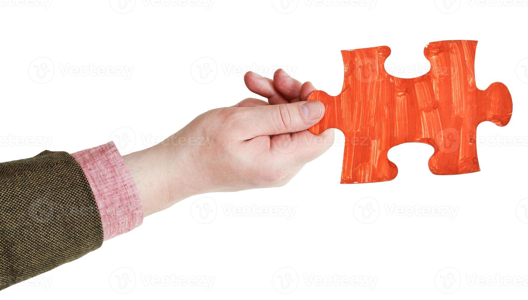 male hand with painted red puzzle piece photo