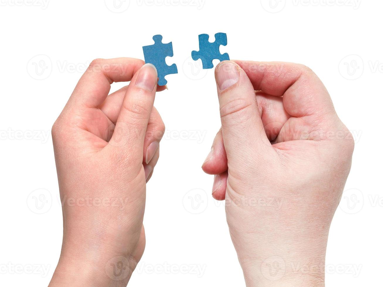 male and female hands with little puzzle pieces photo