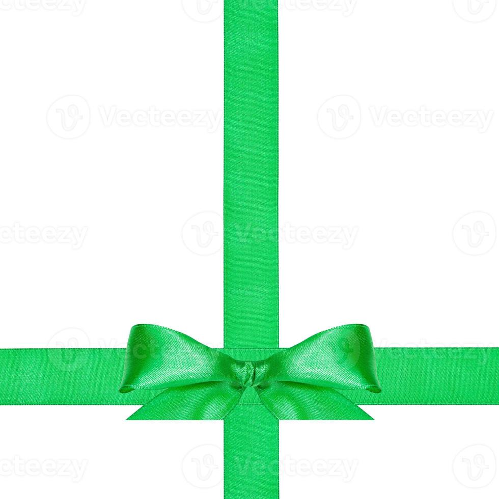 big green bow knot on two crossing satin ribbons photo