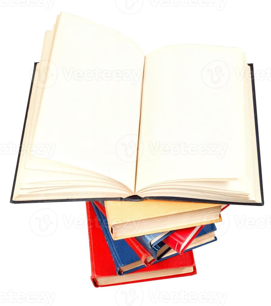 open book on top of stack of books isolated photo