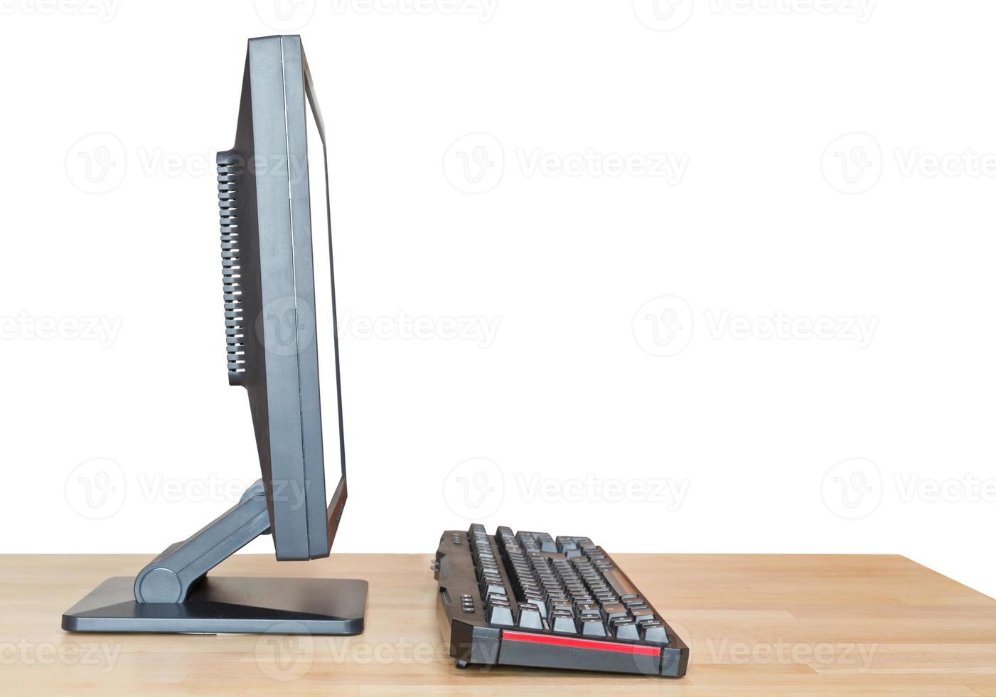 side view computer display and keyboard on table photo