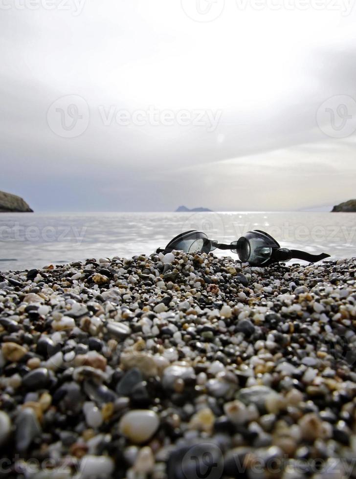 Swimming goggles at Matala beach, Crete, Greece photo