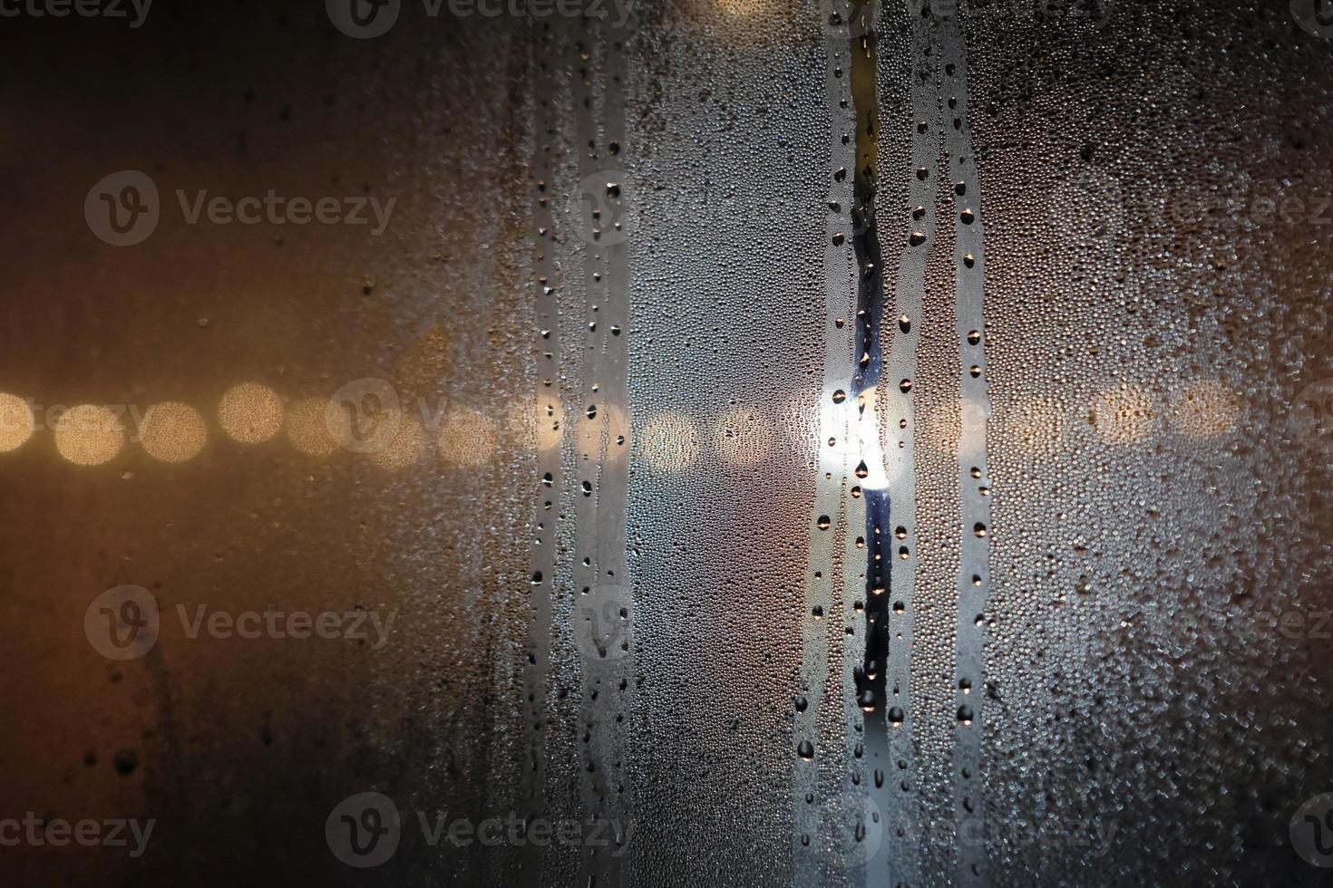 Close-up of condensation on a window at night photo
