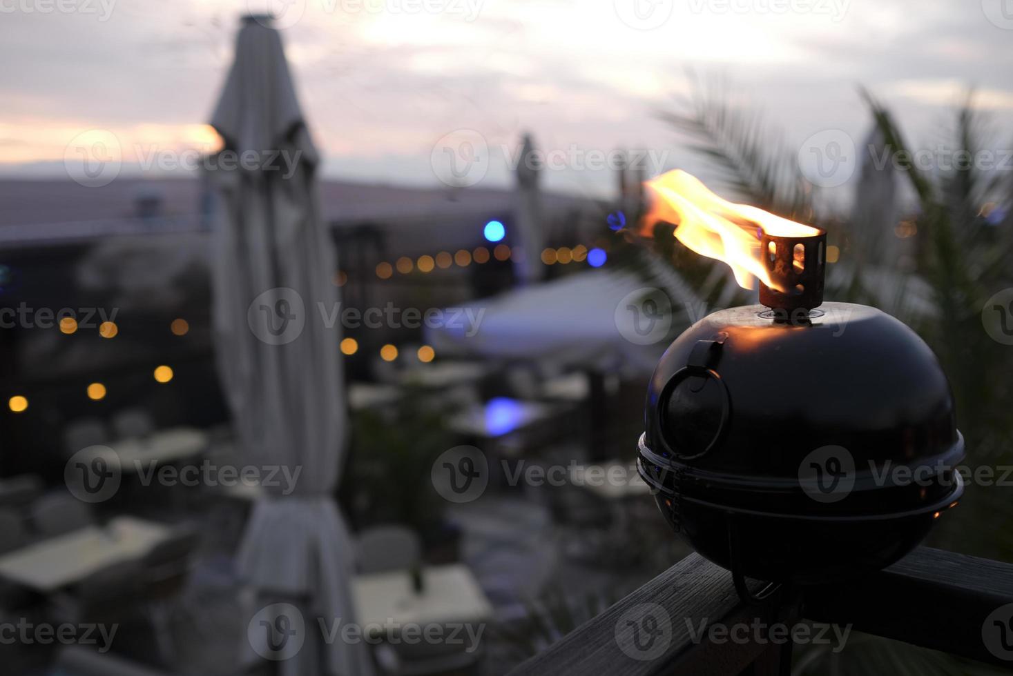 A small oil lamp on a balcony near the coast photo