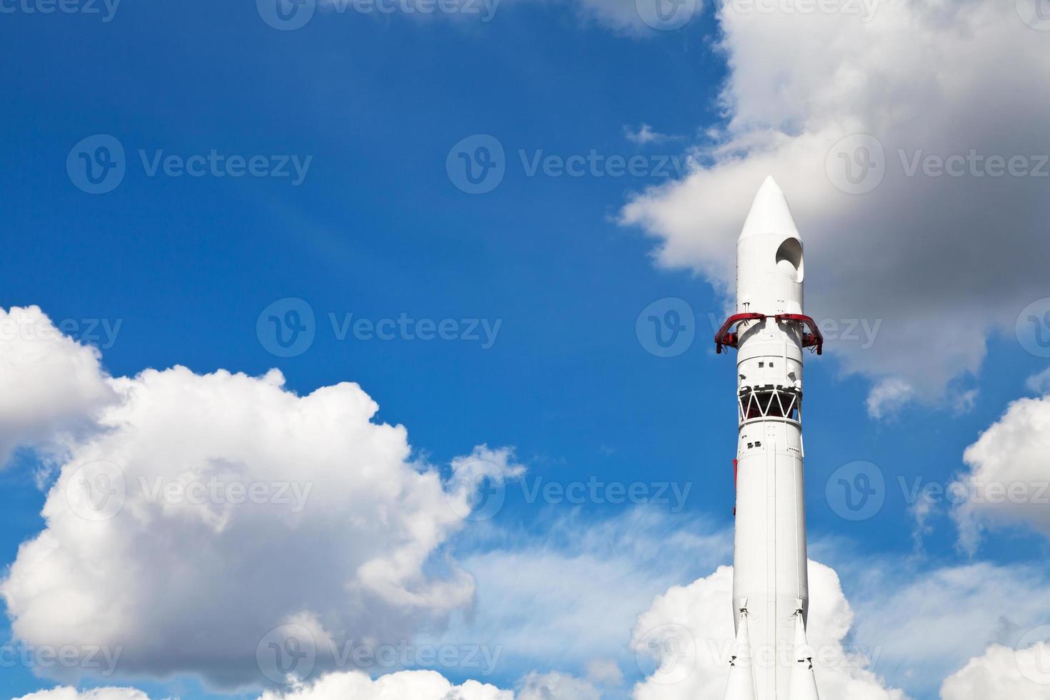 space rocket Vostok and blue sky with clouds photo