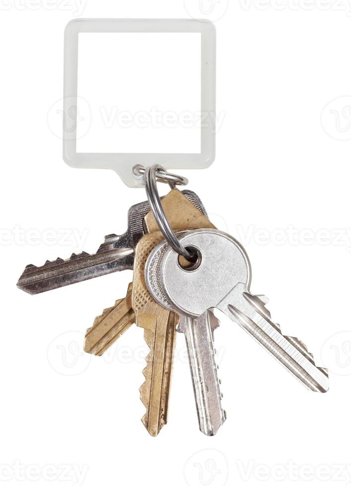 bunch of door keys on ring and square keychain photo