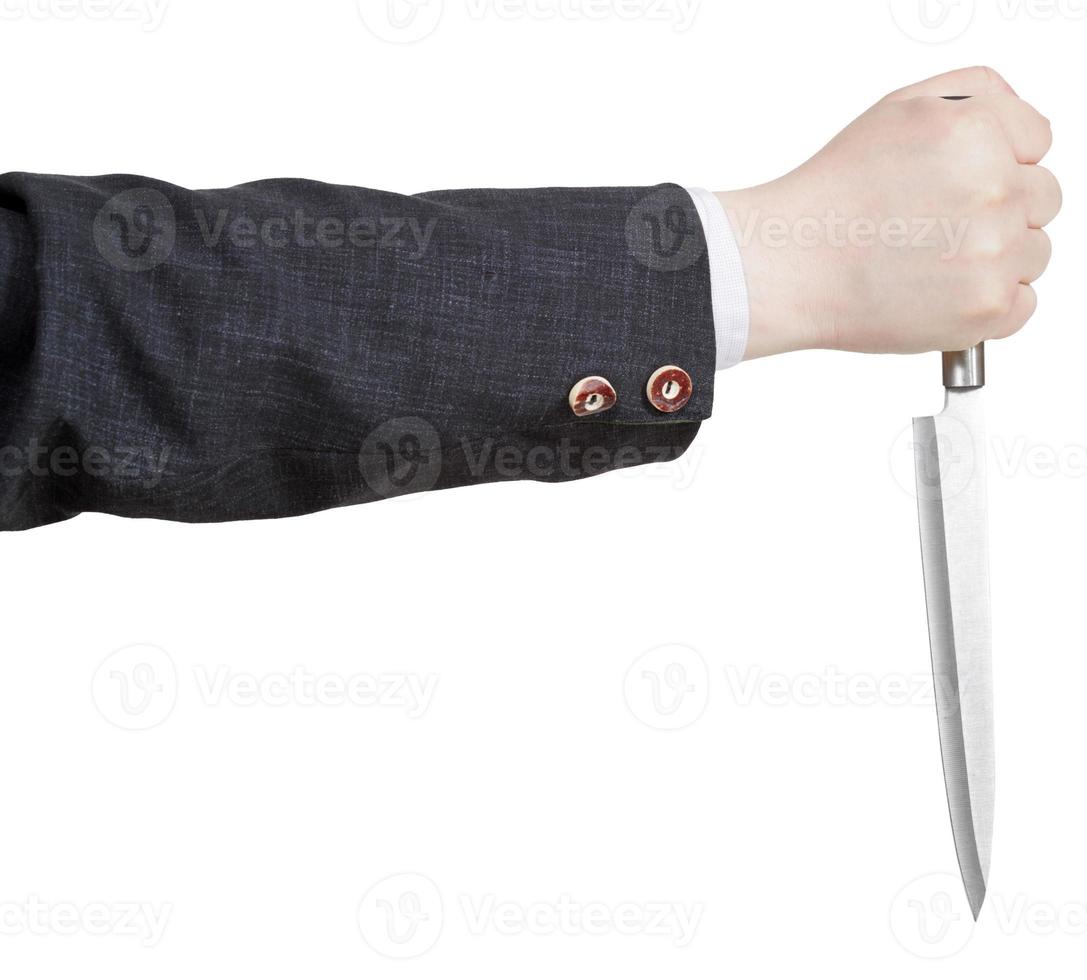 vista lateral del cuchillo en la mano del hombre de negocios foto