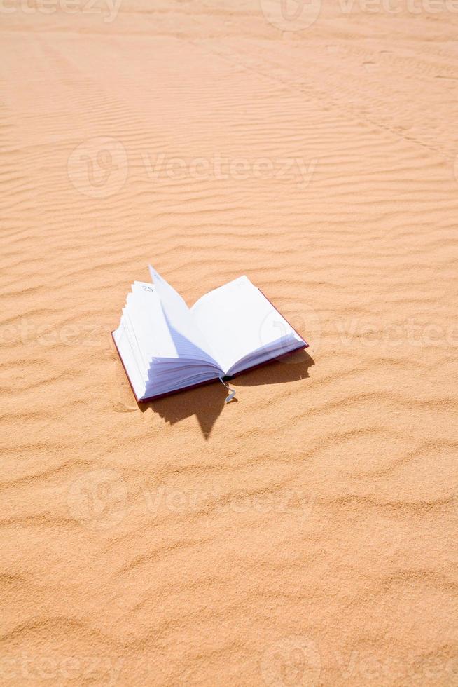 note book on sand dune photo