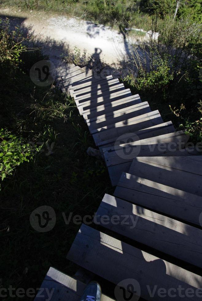 A very long shadow of a person on a flight of stairs photo