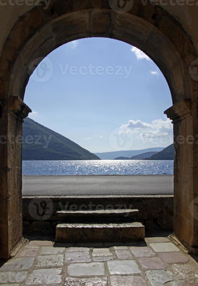 View on the Bay of Kotor, Montenegro, from an arched building entrance in Perast. photo