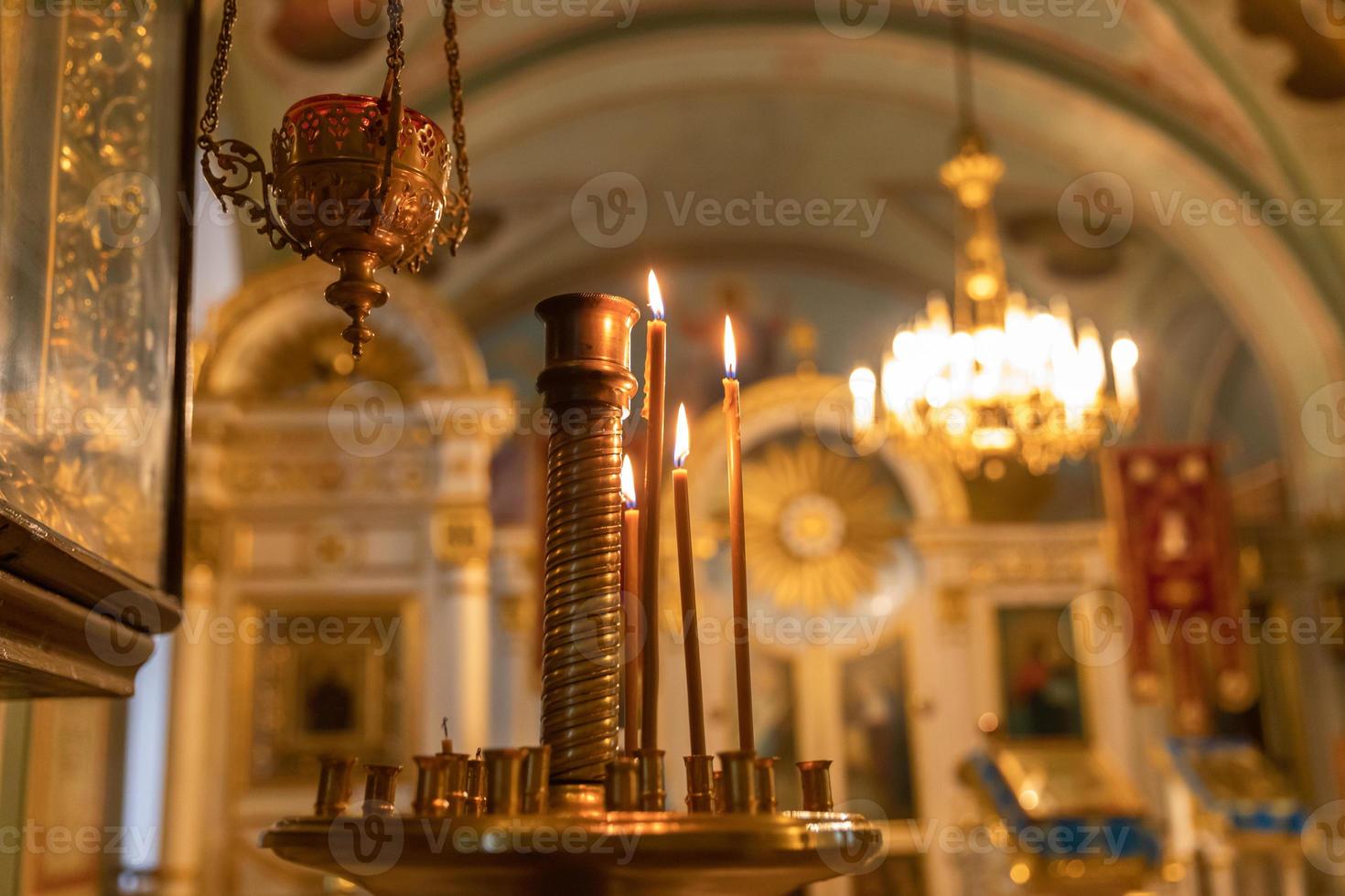 Iglesia Ortodoxa. cristiandad. decoración interior festiva con velas encendidas e icono en la iglesia ortodoxa tradicional en vísperas de pascua o navidad. religión fe orar símbolo. foto