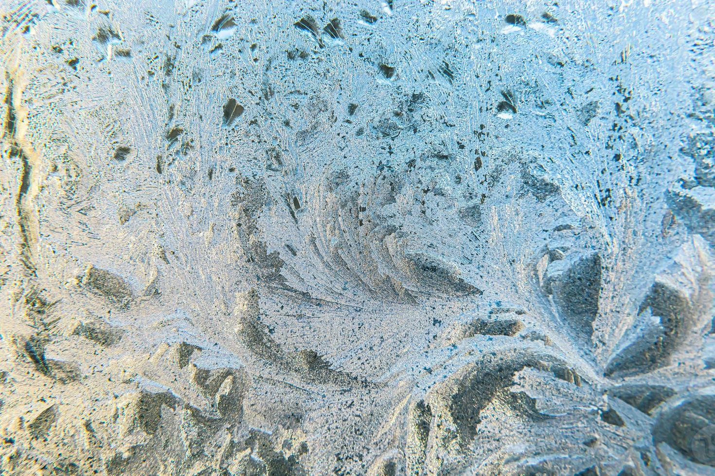 Frozen winter window with shiny ice frost pattern texture. Christmas wonder symbol, abstract background. Extreme north low temperature, natural Ice snow on frosty glass, cool winter weather outdoor. photo