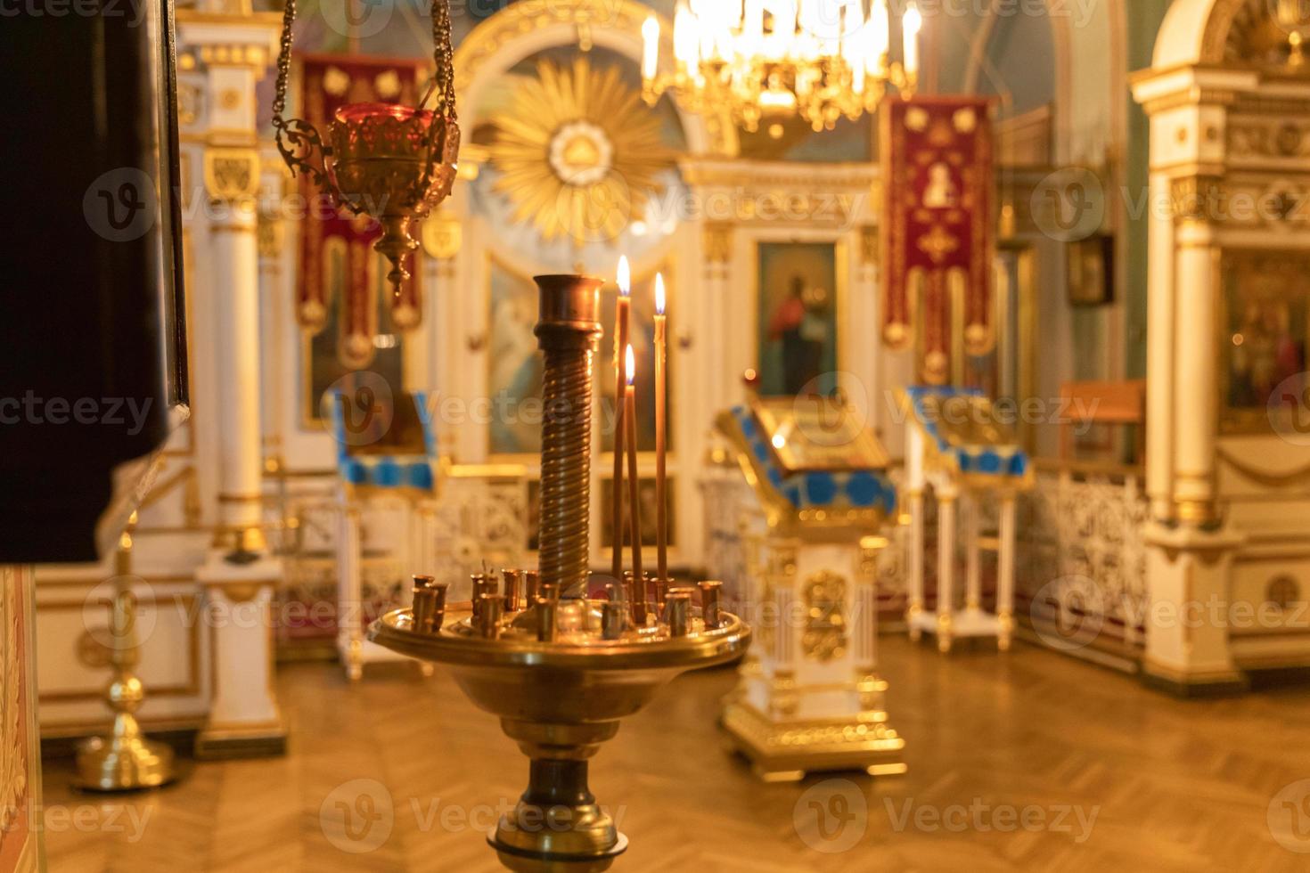 Orthodox Church. Christianity. Festive interior decoration with burning candles and icon in traditional Orthodox Church on Easter Eve or Christmas. Religion faith pray symbol. photo