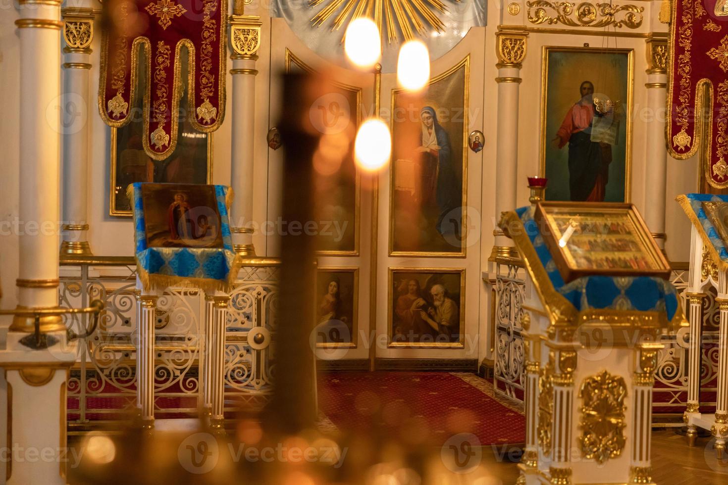 Orthodox Church. Christianity. Festive interior decoration with burning candles and icon in traditional Orthodox Church on Easter Eve or Christmas. Religion faith pray symbol. photo