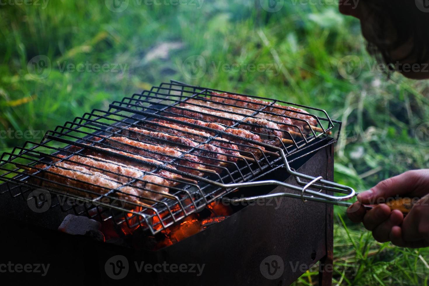 Lulya kebab from meat are prepared in the grill. Shish kebab in the grill. photo