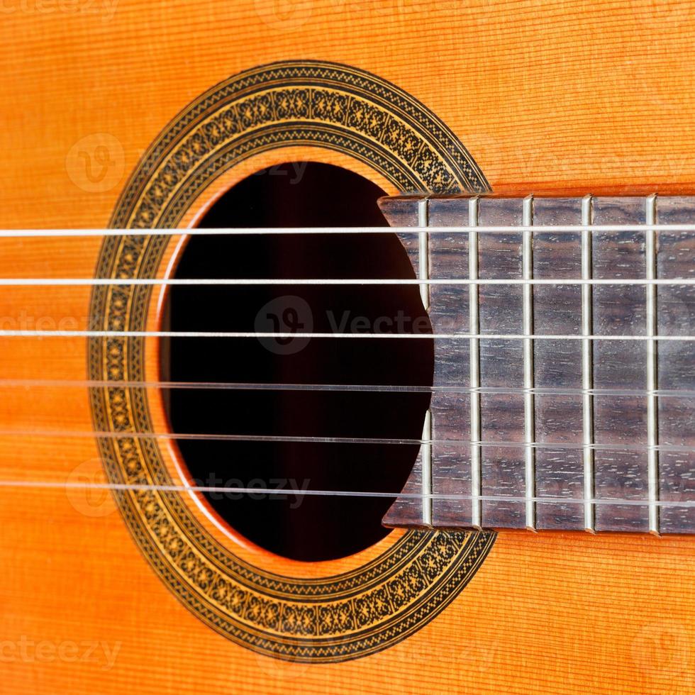 fretboard and sound hole of acoustic guitar photo