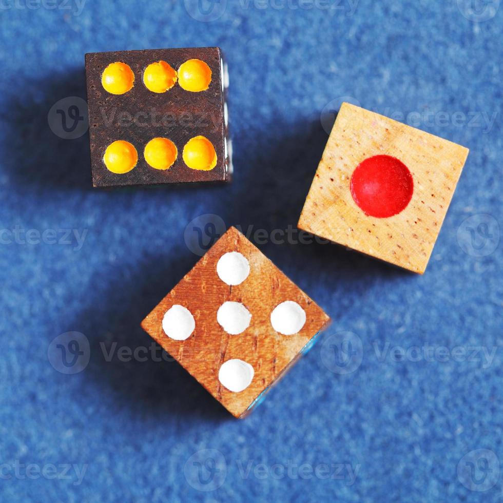 top view of three wooden gambling dices photo