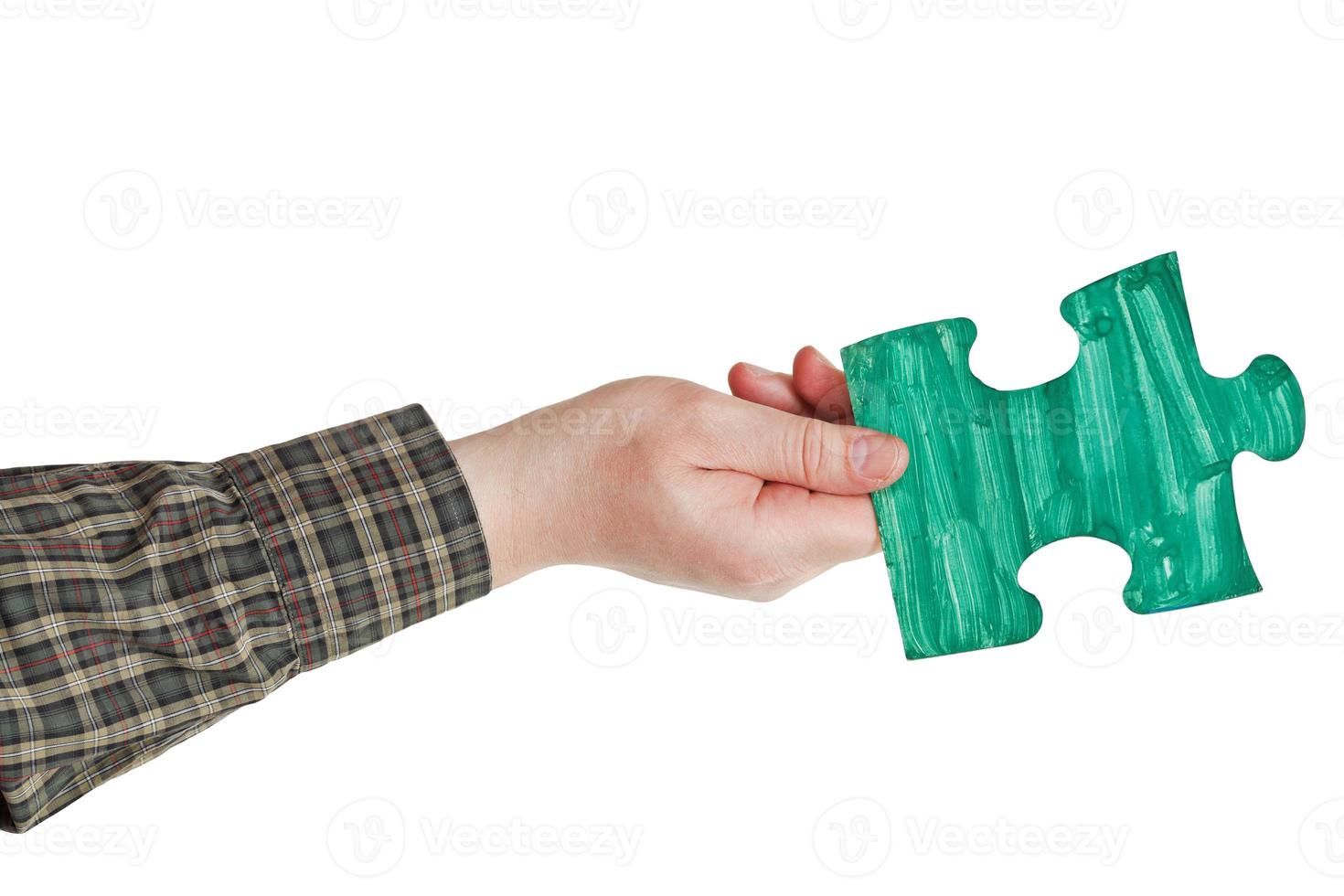 male hand with painted green puzzle piece photo