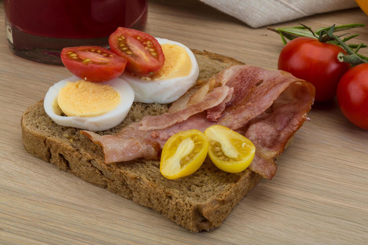 Bacon sandwich on wooden background photo